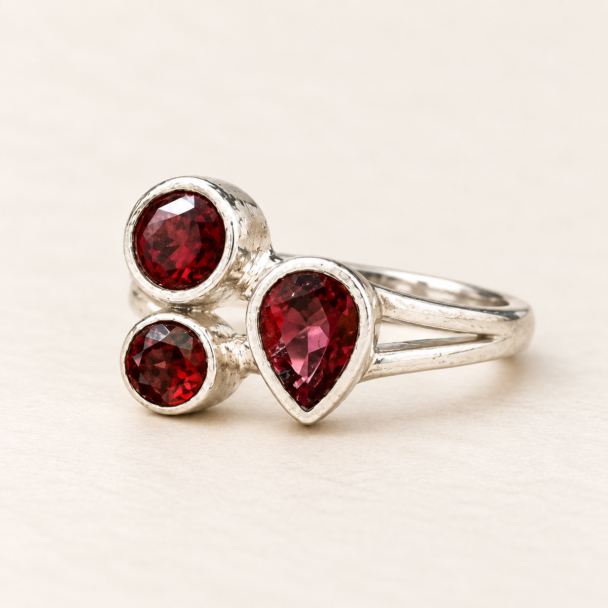 Three-stone garnet sterling silver ring, three-quarter view