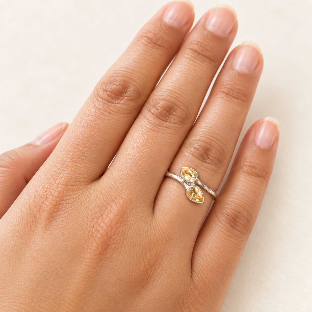 Citrine bypass ring worn on hand