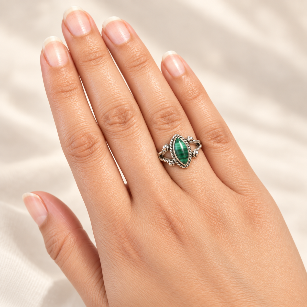 Malachite marquise ring worn on hand
