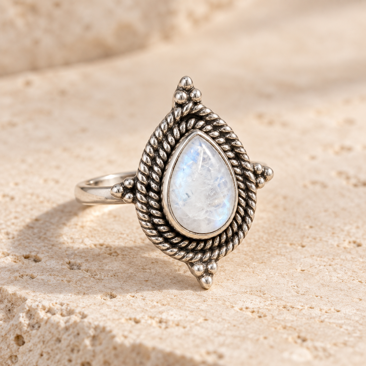 Rainbow moonstone ring on travertine