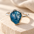 Raw apatite ring on travertine
